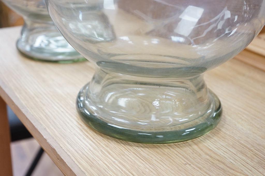 A pair of clear glass chemist's carboys and stoppers, 81cm high including stoppers. Condition - good